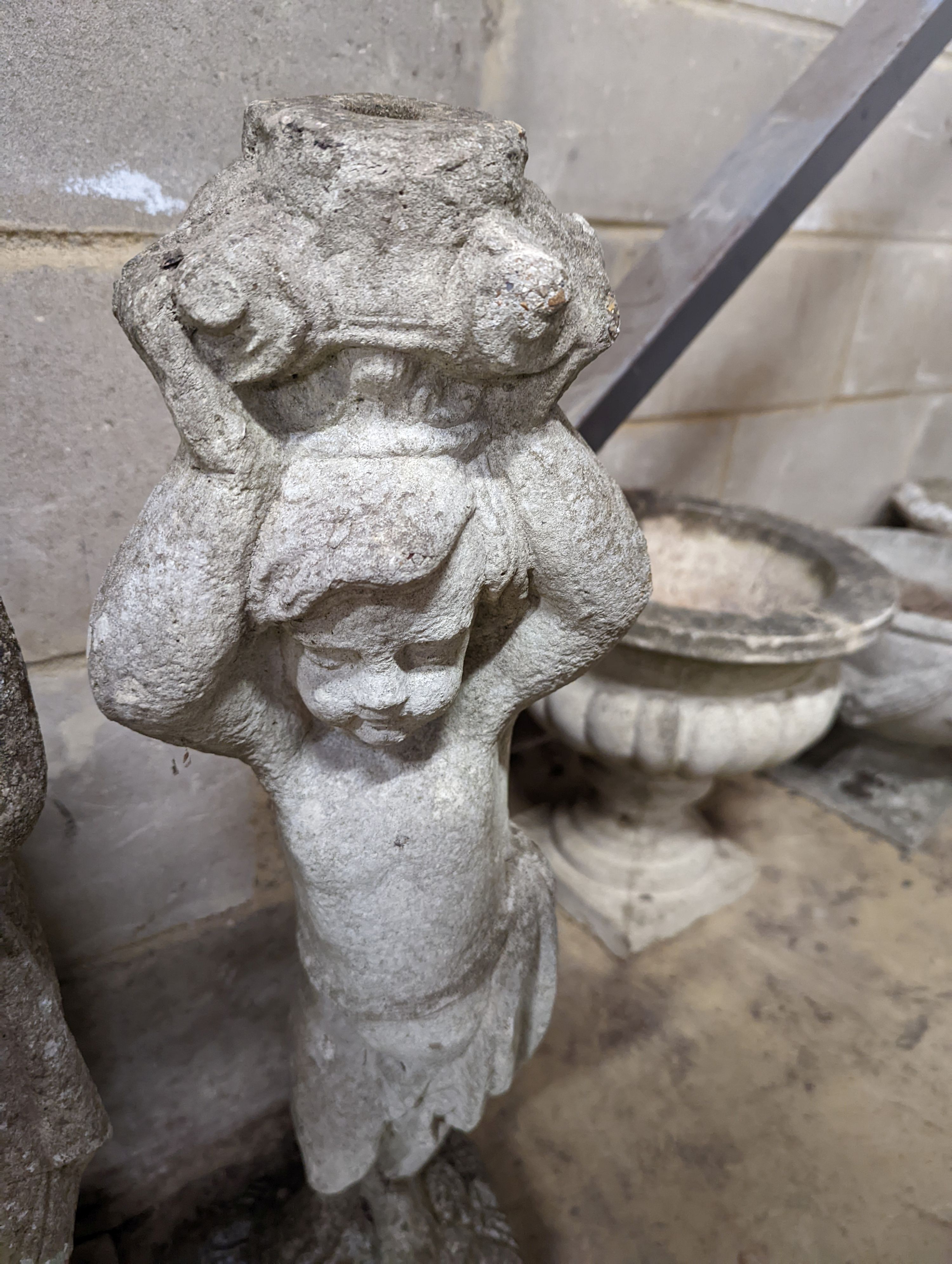A reconstituted stone garden figure, height 80cm together with a stone figural garden column